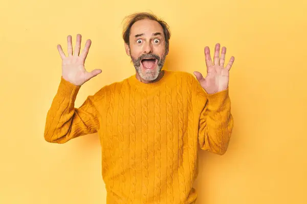 Caucasian Middle Aged Man Yellow Studio Receiving Pleasant Surprise Excited — Stock Photo, Image