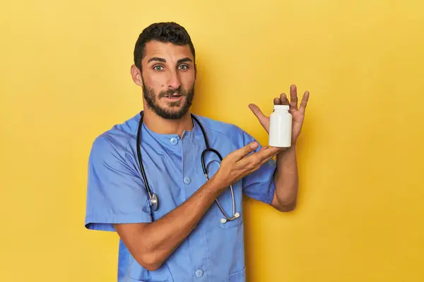 Young Hispanic Nurse Holding Pill Bottle Stock Picture