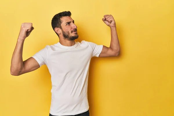 Young Hispanic Man Yellow Background Raising Fist Victory Winner Concept — Stock Photo, Image