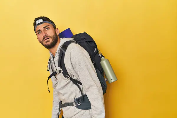 Hispanic man with backpack and headlamp