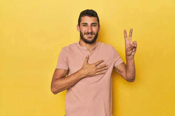 Young Hispanic Man Yellow Background Taking Oath Putting Hand Chest — Stock Photo, Image
