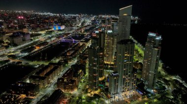 Buenos Aires, Argentina, September 14, 2024: Urban landscape of Puerto Madero at sunset, with the city of Buenos Aires in the background. Aerial night view. clipart