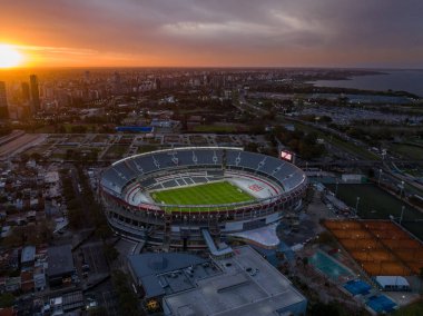 Buenos Aires, Argentina, September 13, 2024: Aerial view of the River Plate football team stadium at sunset. The city of Buenos Aires in the background. clipart