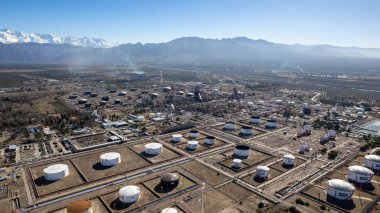 Aerial view of Lujan de Cuyo Refinery, YPF. Snowy Andes mountain range in the background. clipart