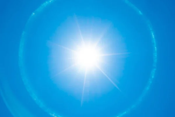sun with halo on blue sky background