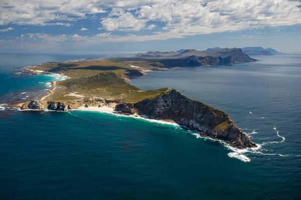 An aerial view of Cape Point and the Cape of Good Hope with Table Mountain in the distance. Cape Town. Western Cape. South Africa