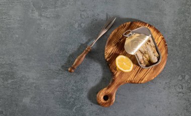 Tinned fish board, sardines in conservas. Mediterranean appetizer platter with lemon. Top view, copy space.