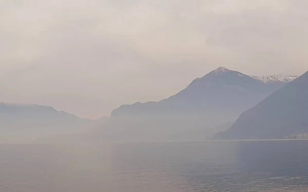 Lake, mountains and mist on a winter day