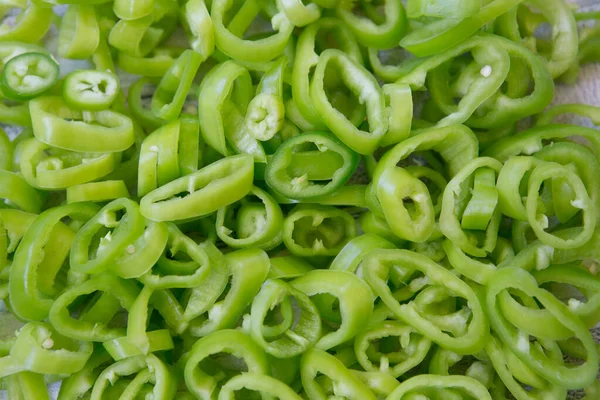 stock image Background of hot green chili pepper cut into pieces.