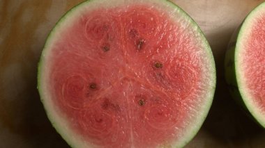 Top view of sliced watermelon on a rustic wooden table clipart