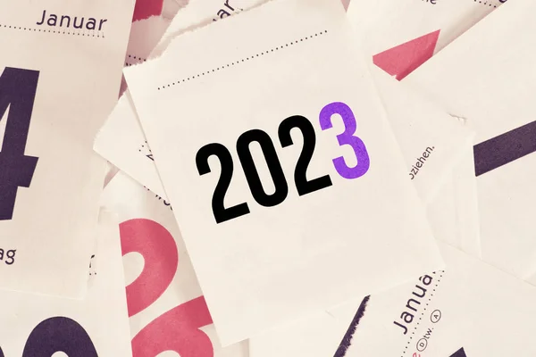2023 calendar on pile of papers for background