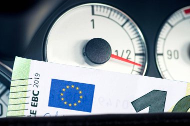 Fuel gauge in the car and euro banknotes clipart