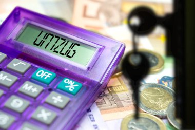 Bir dairenin anahtarları, euro banknotları ve Almanya 'da yeni bir daireye taşınmak için hesap makinesi.