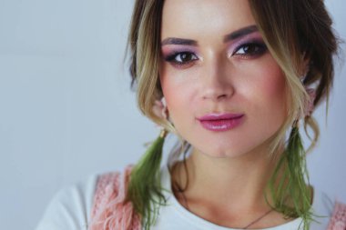 Profesyonel makyaj küpeli güzel kadınla.