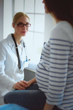 Hastanede doktorla gülümseyen güzel bir hamile kadın..