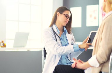 Doktor ve hasta masada otururken bir şey tartışıyorlar. Tıp ve sağlık hizmetleri kavramı. Doktor ve hasta..