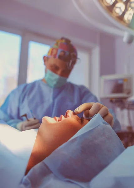 stock image Man surgeon at work in operating room.