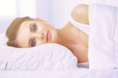 Genç ve güzel bir kadın yatakta yatıyor..