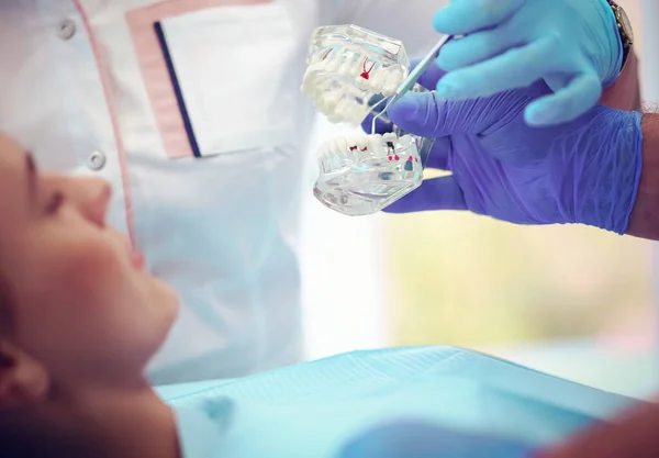 治疗年轻女病人牙齿的牙医的画像 — 图库照片