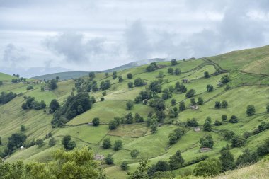Rustic stone shepherds cabins in a hill with green meadows 