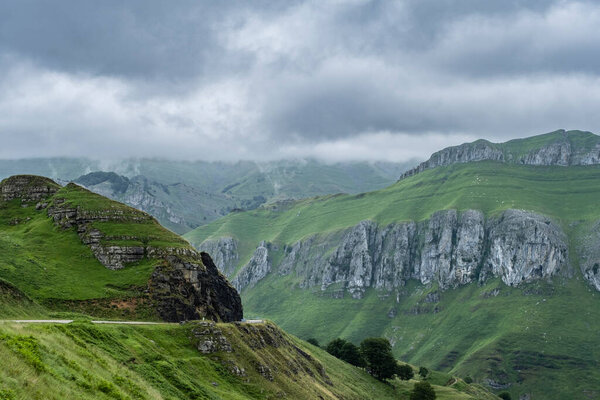 Rough mountain landscape with green and steep limestone slopes in Valles Pasiegos, Cantabria, Spain