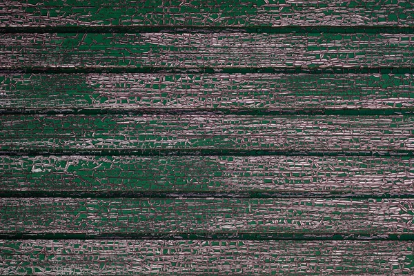 stock image Old green painted wooden planks wall with weathered cracked paint making a craquelure pattern, grunge rustic textured background  