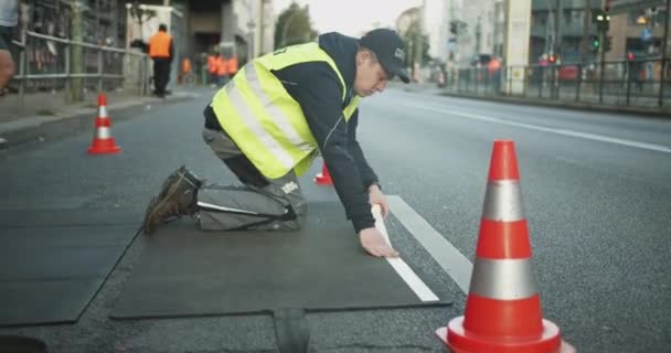 Organizers Preparing Street Sports Event Installing Rubber Protection Cables Marathon — Stock Video