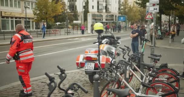 舗装された道路に立って 街の通りでハンドバイクレースを見て救急車 マラソンランレース ベルリン ドイツ — ストック動画