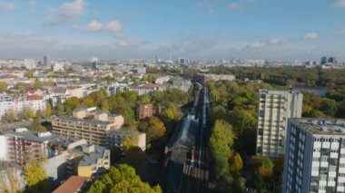 Ön taraflar tren yolu üzerinde trafik ile uçar. Şehir merkezinden geçen çeşitli trenler. Metropolün havadan panoramik görüntüsü. Berlin, Almanya.