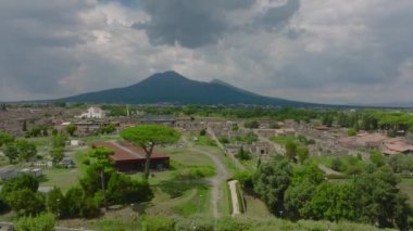 Roma şehrinin havadan çekilmiş görüntüleri var. Büyük volkanik patlamadan sonra kasaba yok olmuş. Arka planda Vezüv Dağı volkanı var. Pompei, İtalya.