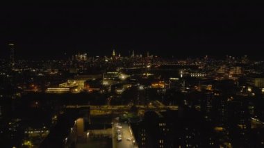 Geceleri şehrin havadan panoramik manzarası. Ana yol yoğun, aydınlatılmış binalar ve arka planda Manhattan gökdelenleri. New York City, ABD.
