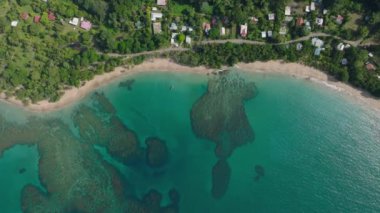 Gorgeous aerial view of tropical islands shimmering waters. Overhead view of exotic beach lush greenery