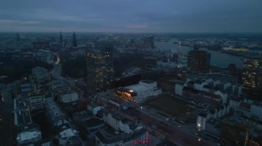 Aerial panoramic view of evening city. Modern design building Tanzende Turme and Stage Operettenhaus with large illuminated banners. Hamburg, Germany.