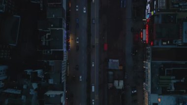 Top down panning footage of vehicles driving on wide Reeperbahn boulevard in evening. Hamburg, Germany.