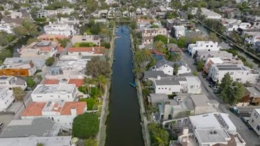 Geriye dönük olarak, tropikal bölgelerdeki Venedik Kanalları boyunca uzanan lüks aile evleri ortaya çıktı. Los Angeles, Kaliforniya, ABD.