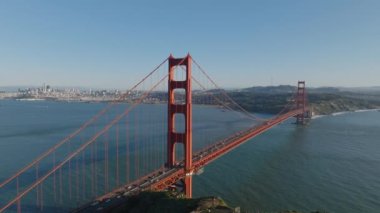 Önemli caddelerdeki yoğun trafiğin güzel görüntüleri. Ünlü Golden Gate Köprüsü altın saatinde güneşle aydınlandı. Şehrin arka planında binalar var. San Francisco, California, ABD.