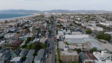 Venedik yerleşim yerindeki şehir gelişiminin hava panoramik görüntüsü. Geniş kumsallı ve arka planda dağlar olan deniz kıyısını kapatın. Los Angeles, Kaliforniya, ABD.