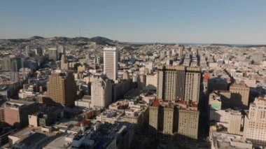 Şehir merkezindeki binaların üzerinde altın saat uçuyor. Ünlü Westin St Francis Oteli sabah güneşiyle aydınlandı. San Francisco, California, ABD.