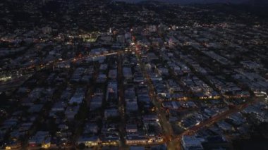 İleri uçaklar gece yerleşim yerlerinin üzerinde uçar. Şehrin yukarısındaki tepeleri göster. Los Angeles, Kaliforniya, ABD