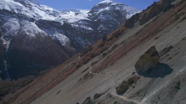 Himalaya 'nın yüksek dağlarındaki Tilicho ana kampına giden şerpalarla birlikte hava aracı görüş alanında yakınlaşıyor. Annapurna gezisi. Turizm ve Nepal 'de yürüyüş.