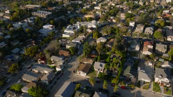 城市社区房屋的高角视图 建筑物和绿树被低垂的阳光照亮 倾斜着露出远处的山脊 美国加利福尼亚州洛杉矶 — 图库视频影像