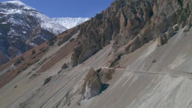 Hava kuşları, güneşli hava koşullarında yüksek himalaya dağlarındaki Tilicho ana kampına giderken yürüyüşçüleri izliyor. Nepal 'de yürüyüş yolları ve güzel manzaralar..