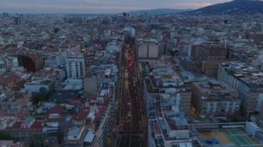 Forvetler çok şeritli bir şehrin üzerinde uçuyor. Alacakaranlıkta Metropolis 'in havadan panoramik görüntüsü. Barselona, İspanya.