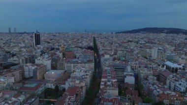 Alacakaranlıktaki Metropolis 'in havadan panoramik görüntüsü. Şehir merkezindeki yoğun şehir merkezinden geçen düz bir cadde. Barselona, İspanya.