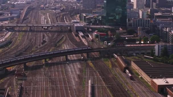 Train Unit Passing Bridge Spanning Wide Railway Yard City Aerial — Stock Video