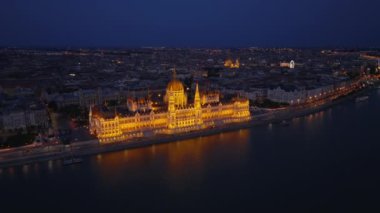 Gece Macar parlamentosunun güzel tarihi binası. Rıhtımda aydınlık bir yer. Budapeşte, Macaristan.