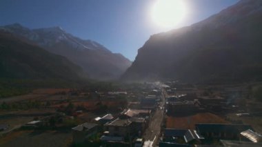 Kuşların gözü gündoğumunda Humde köyündeki evlerin üzerinde uçuyor. Annapurna gezisi. Marshyangdi Vadisi. Himalayalar 'ın sıradağları. Nepal konutları mimari ve yaşam tarzı konsepti