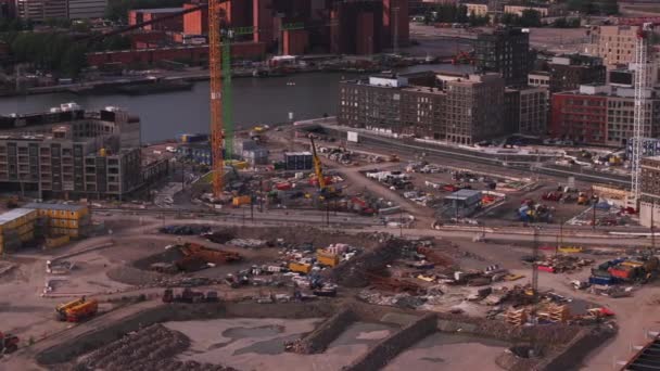 Aerial View Construction Site Waterfront Tower Cranes Ground Machinery Tilt — Stock Video