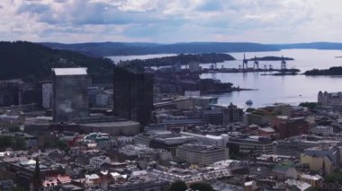 Şehir merkezindeki modern yüksek binaların hava kaydırak ve pan görüntüleri. Arka planda büyük vinçler var. Oslo, Norveç.