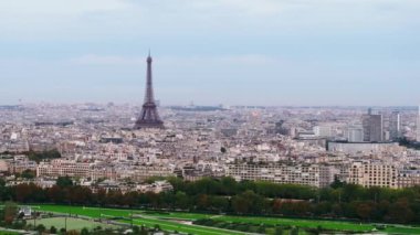Şehirdeki çok katlı binalar ve yüksek Eyfel Kulesi. Popüler turist manzarası kasabanın gelişiminin üzerinde yükseliyor. Metropolis 'te bulutlu bir gün. Paris, Fransa.